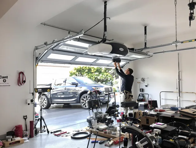 Boynton Beach Garage Door Repair specialist installing smart garage door opener system in Boynton Beach home